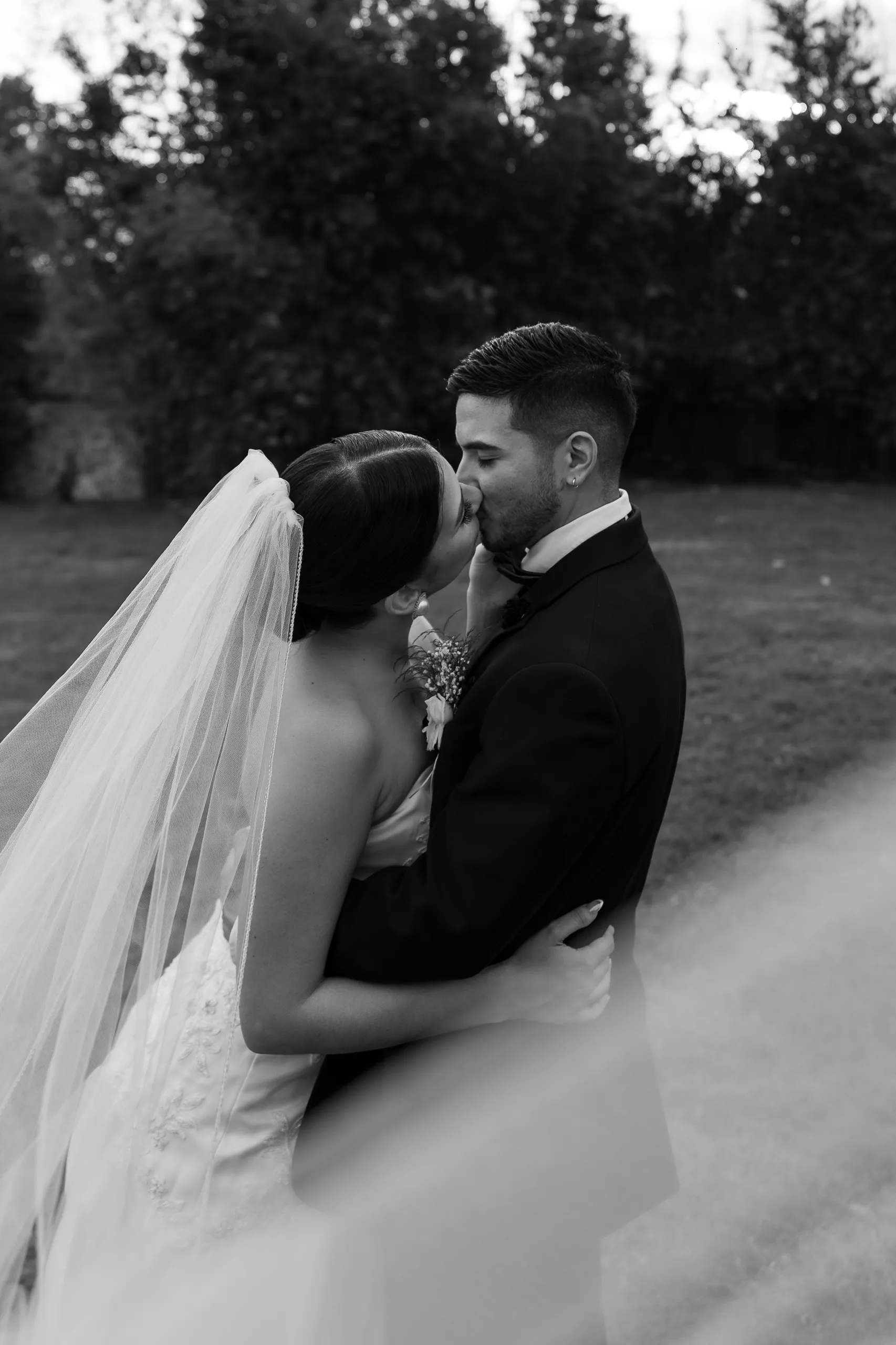 Black-and-white portrait of the newlyweds kissing at The Hill House, Clermont FL