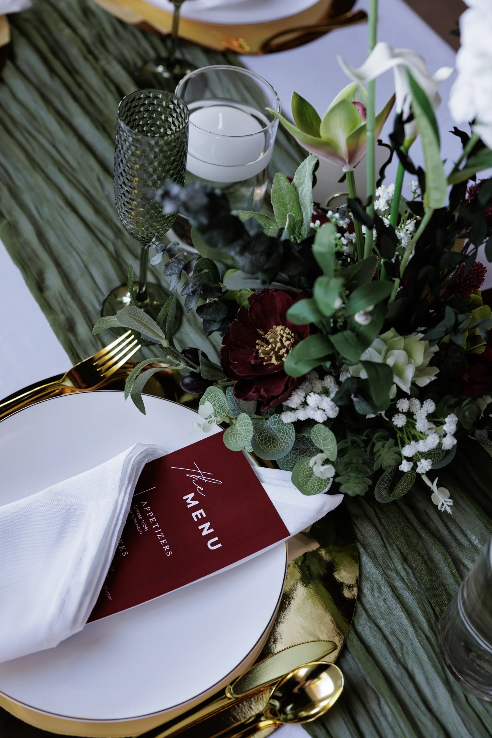 Reception place setting with sage runner and burgundy florals at The Hill House, Clermont FL