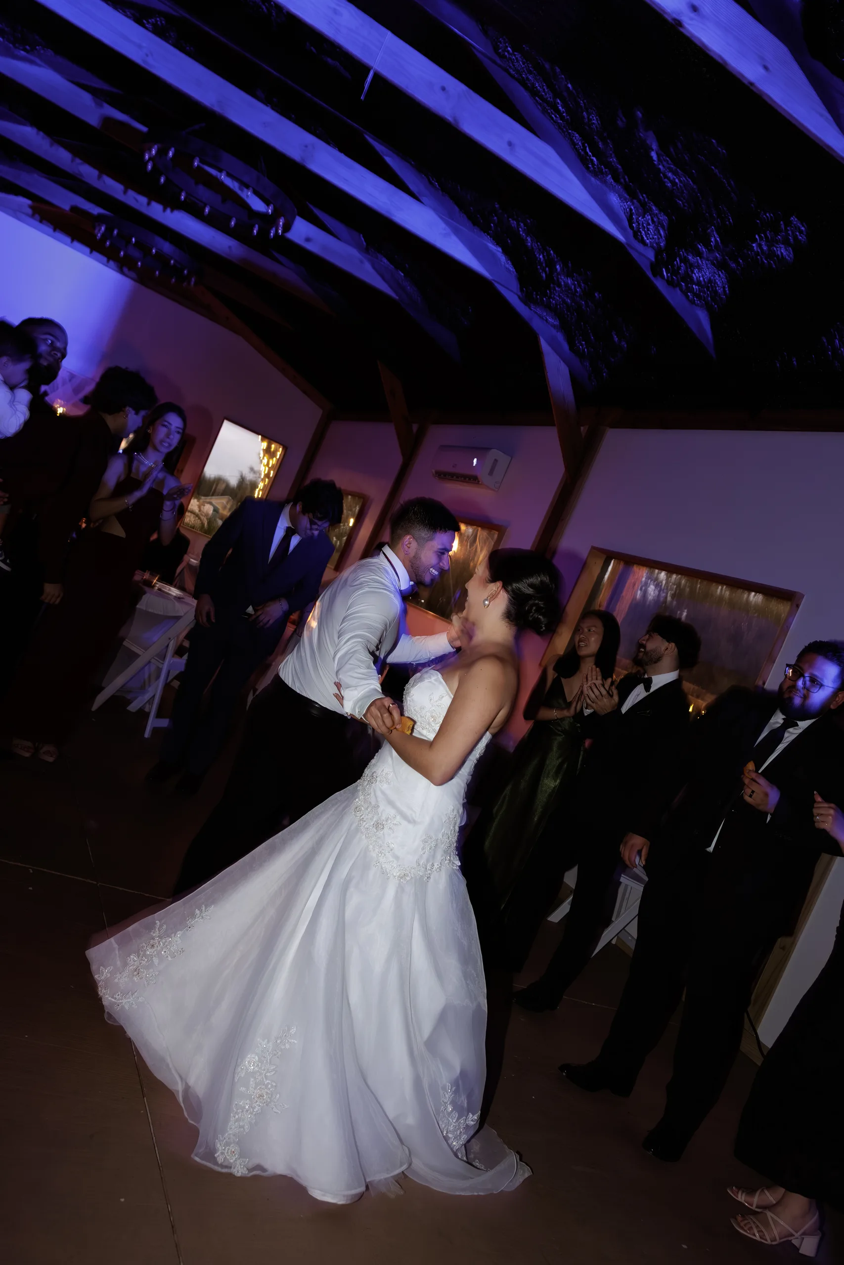 First dance under the timber-beam ceiling and blue uplighting at The Hill House, Clermont FL