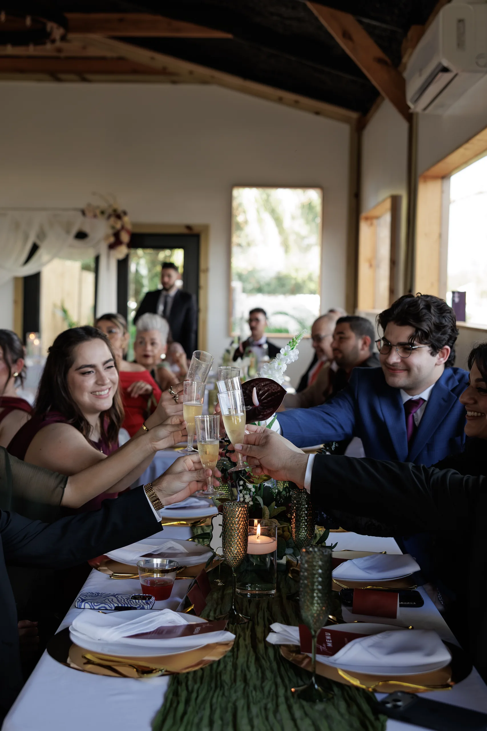 Guests raising glasses for a toast at The Hill House reception, Clermont FL