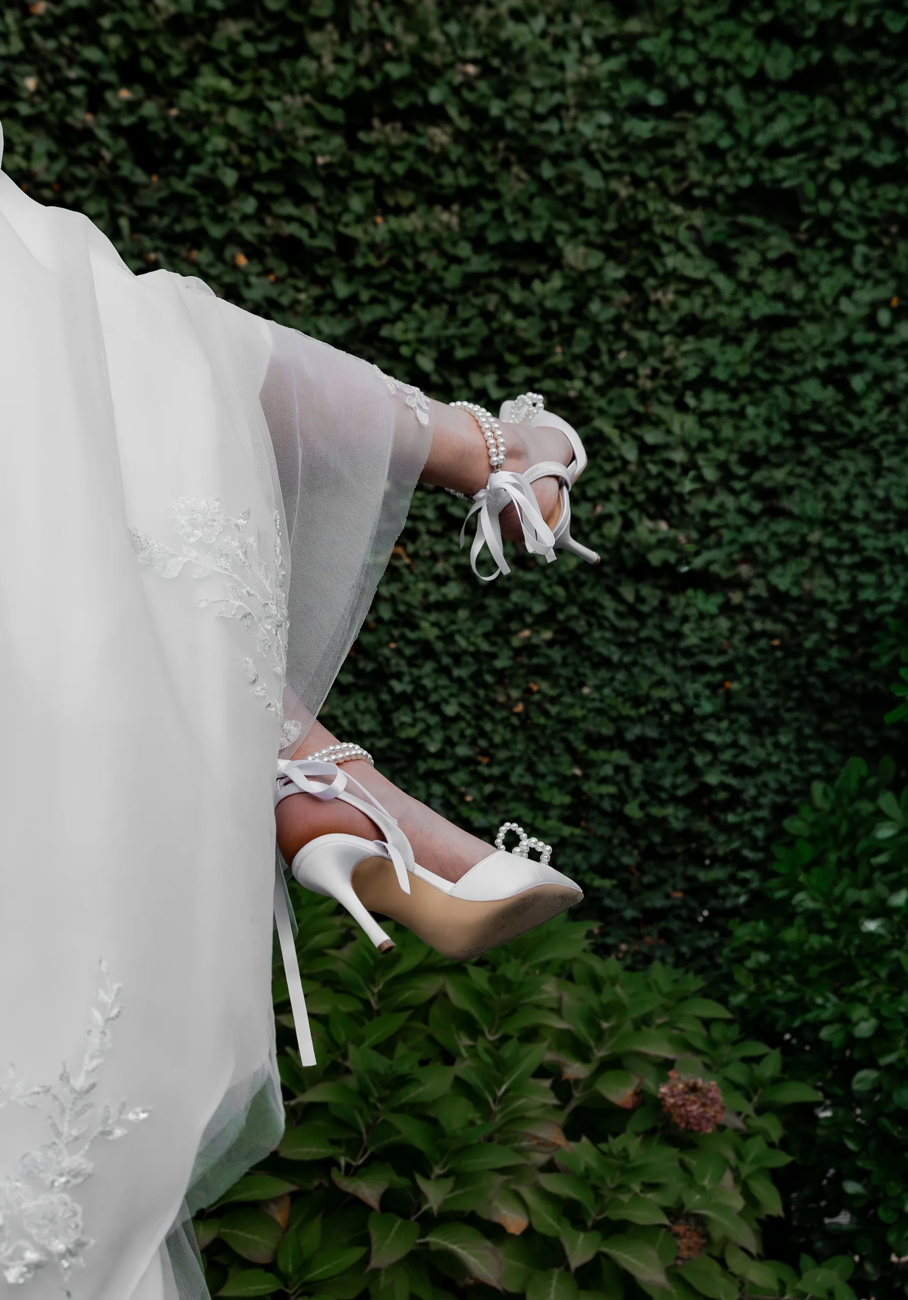 Bride's pearl-detailed heels against the ivy wall at The J House Greenwich, Greenwich CT
