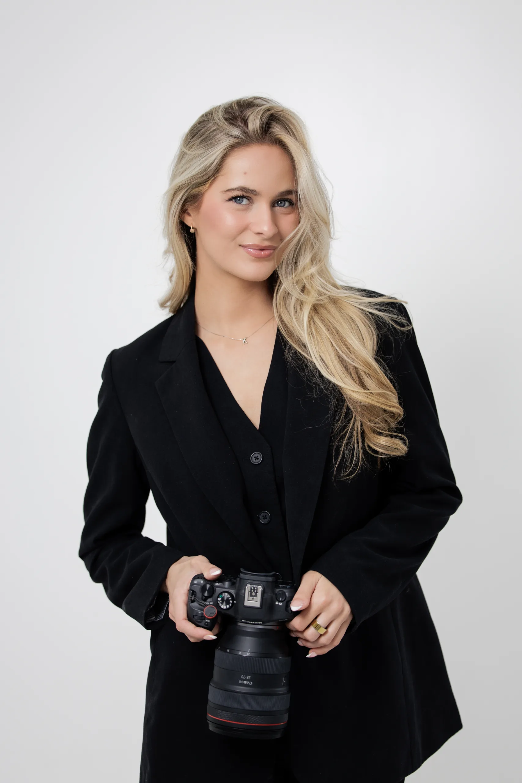 Kendyl Hodges, Orlando wedding photographer and owner of CBK Studios, holding her Canon camera