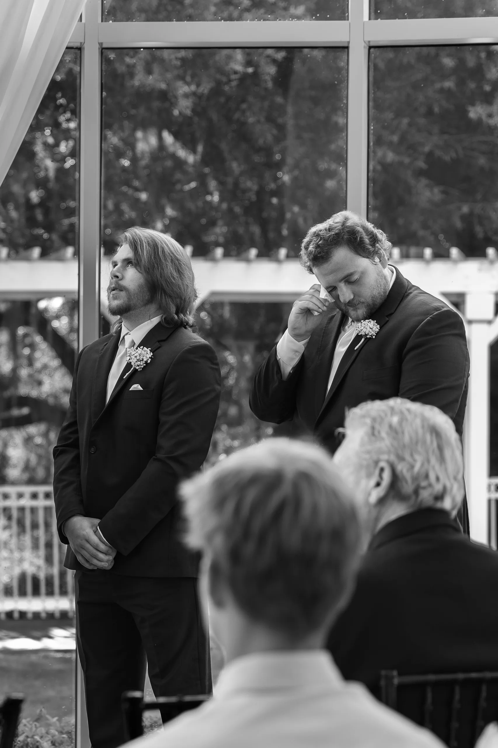 Groomsmen tearing up during the ceremony at Lake Mary Events Center