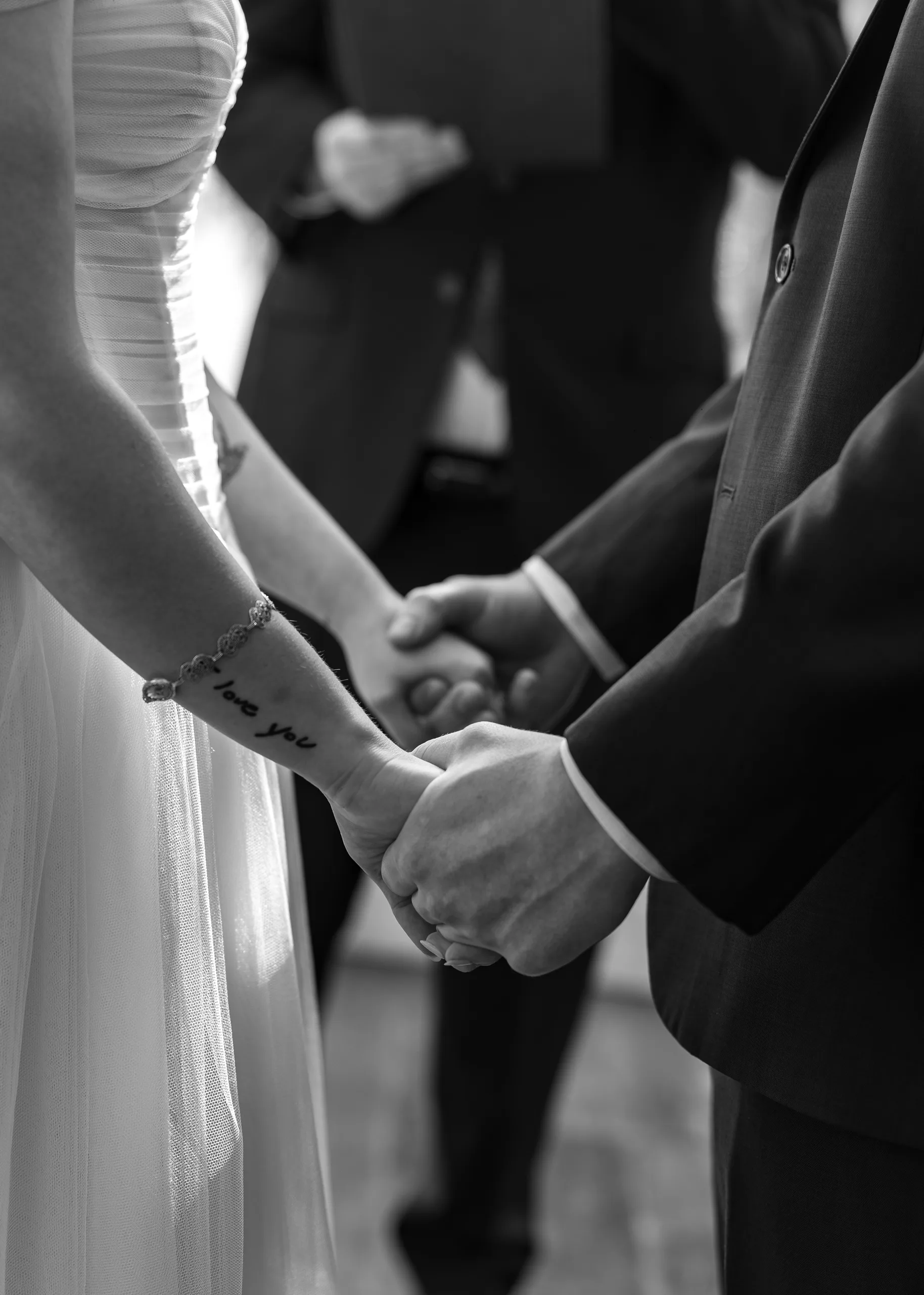 Bride and groom holding hands during their vows at Lake Mary Events Center