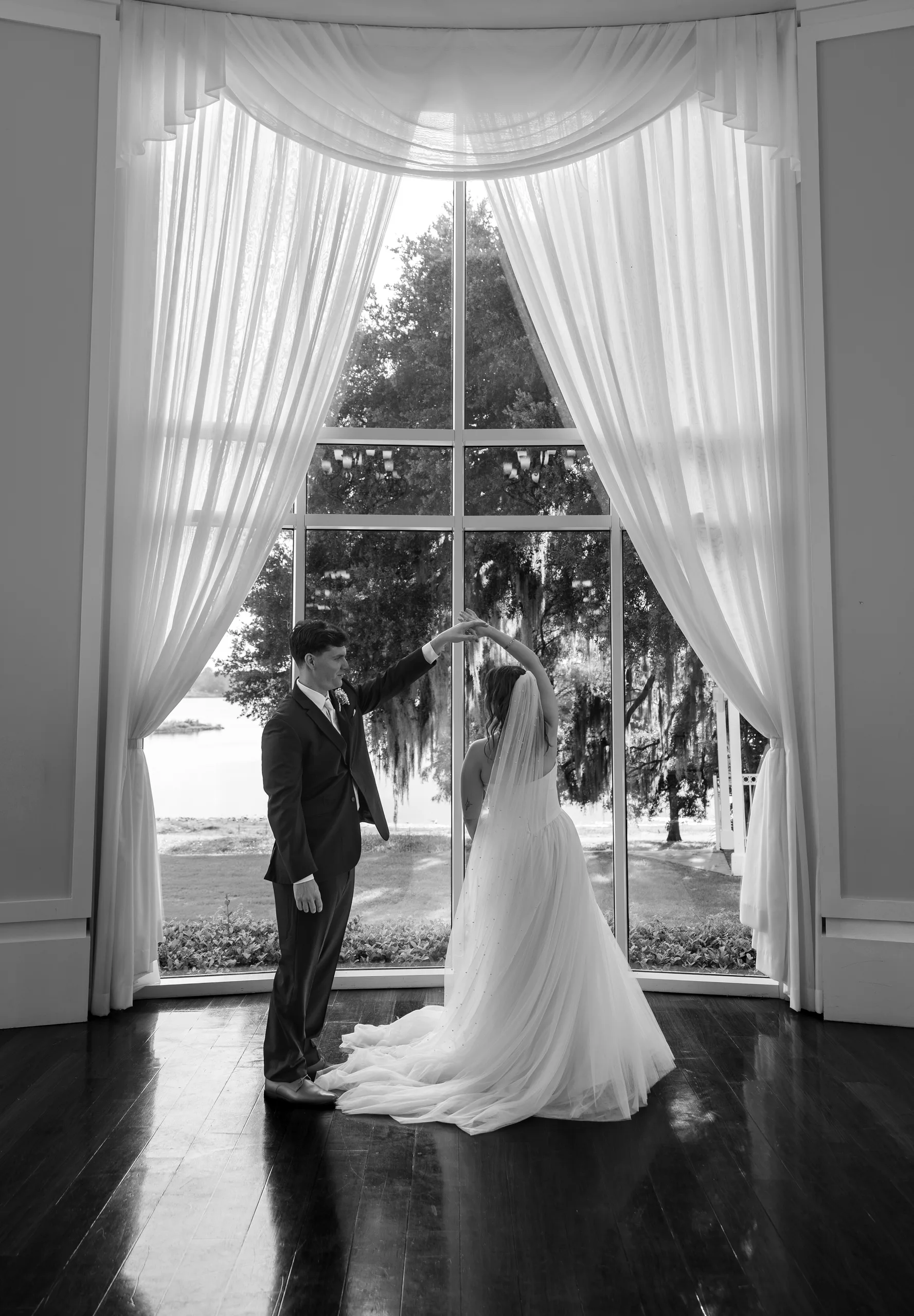 Bride and groom dancing together in the sunroom at Lake Mary Events Center