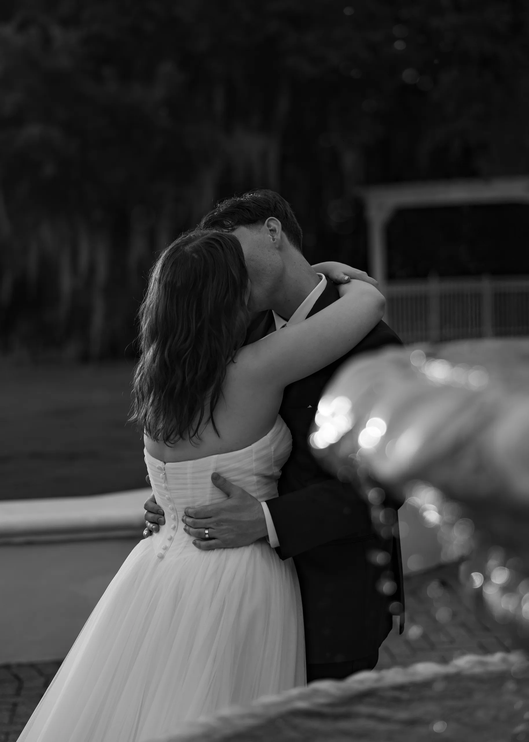 Bride and groom embracing outdoors in the evening light at Lake Mary Events Center