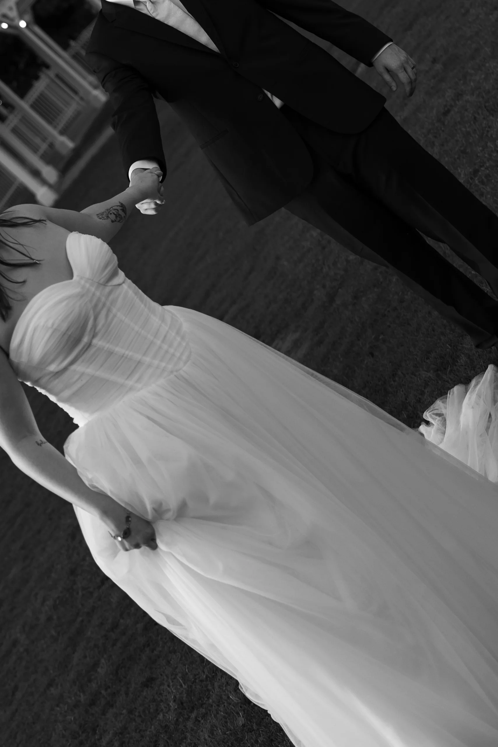 Overhead view of the bride and groom holding hands on the lawn at Lake Mary Events Center