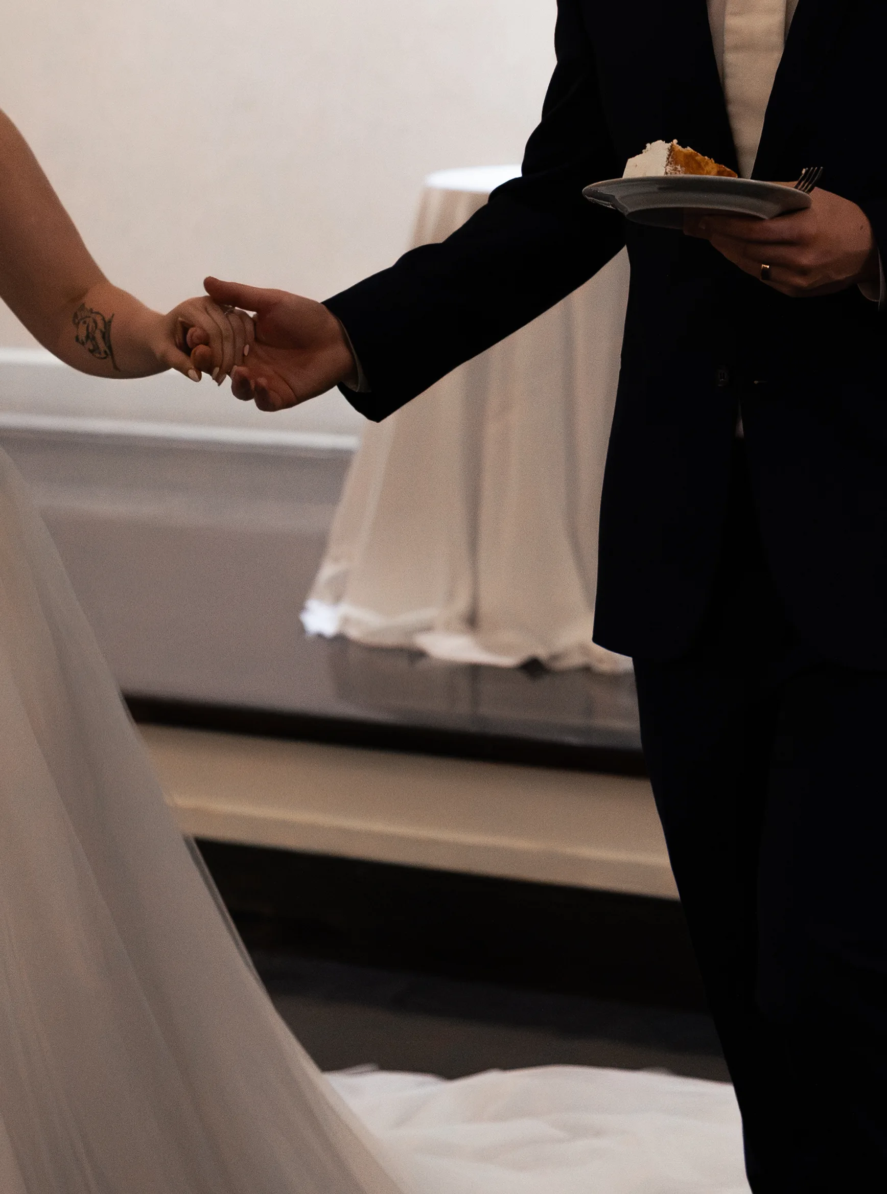 Newlyweds share the first bite of cake at their reception at Lake Mary Events Center